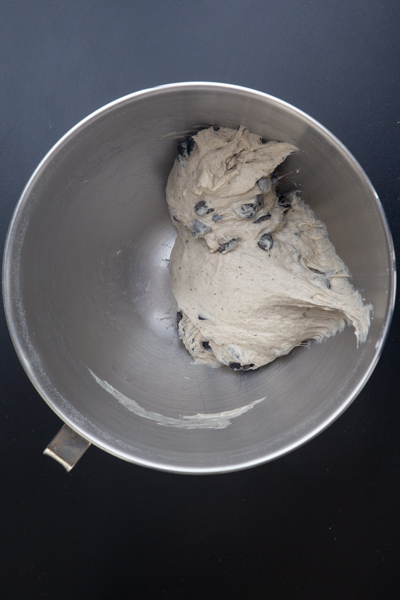Dough kneaded in silver mixing bowl.
