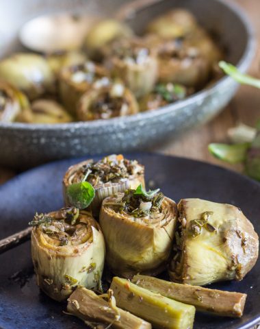 cooked roman artichokes in a pan and 3 on a plate