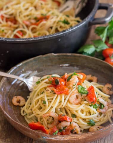 Shrimp pasta on a plate and in a pan.