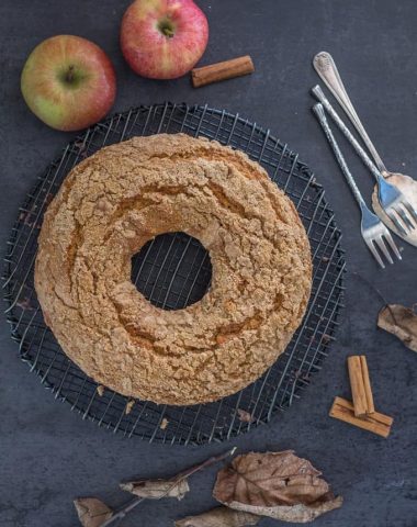 applesauce cake on a black board with whole apples