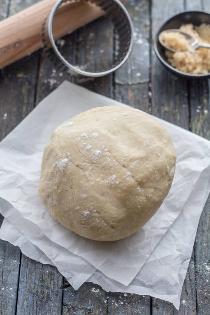 Brown sugar pie crust on a piece of parchment paper.