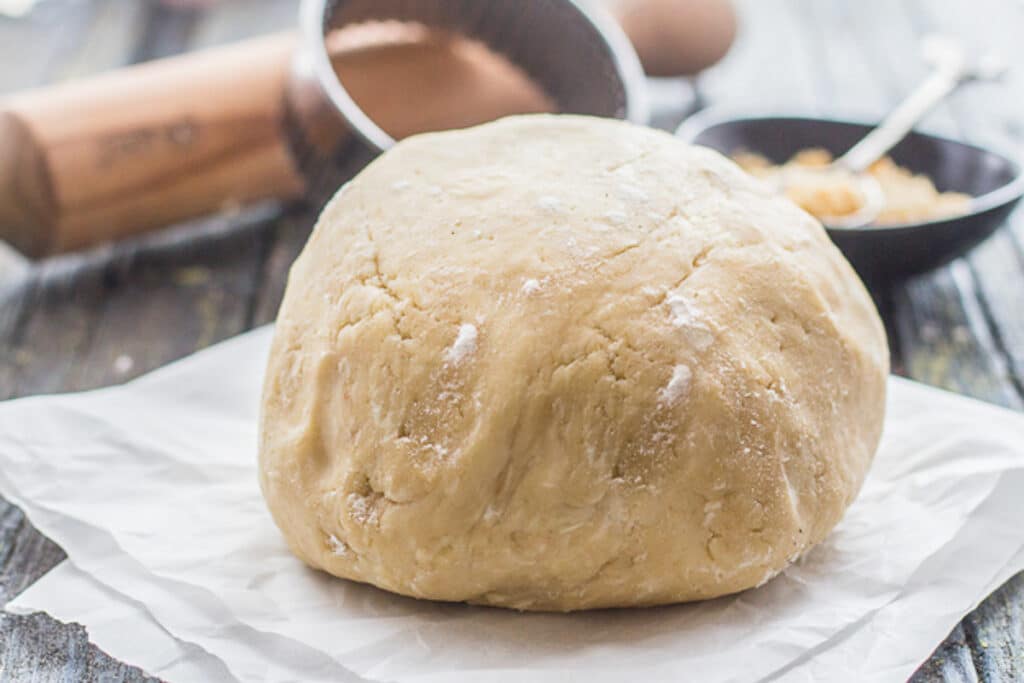 Brown sugar pie crust on a piece of parchment paper.