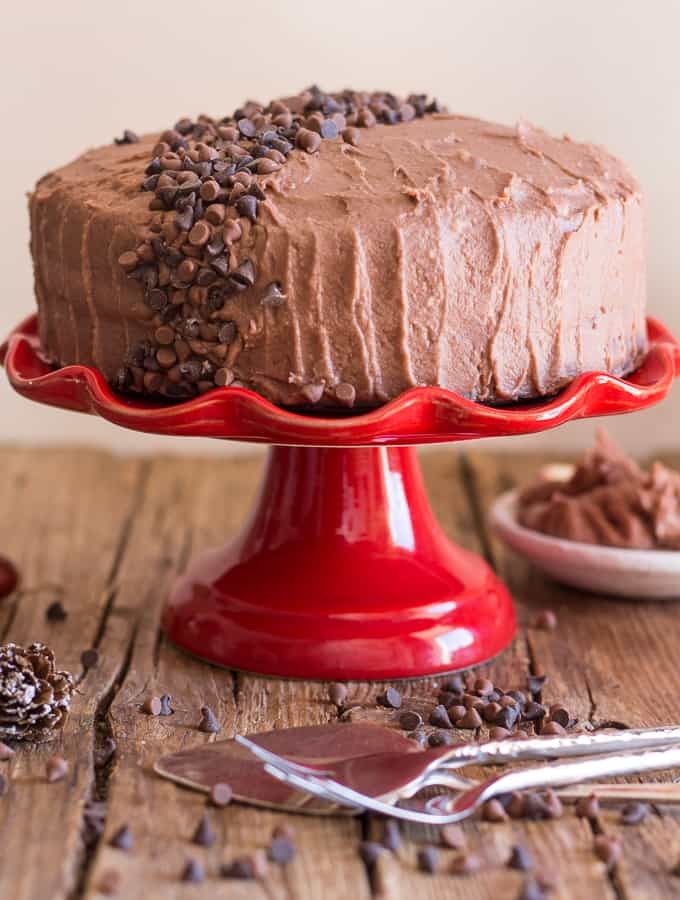 chocolate cake with mocha icing on a red cake stand