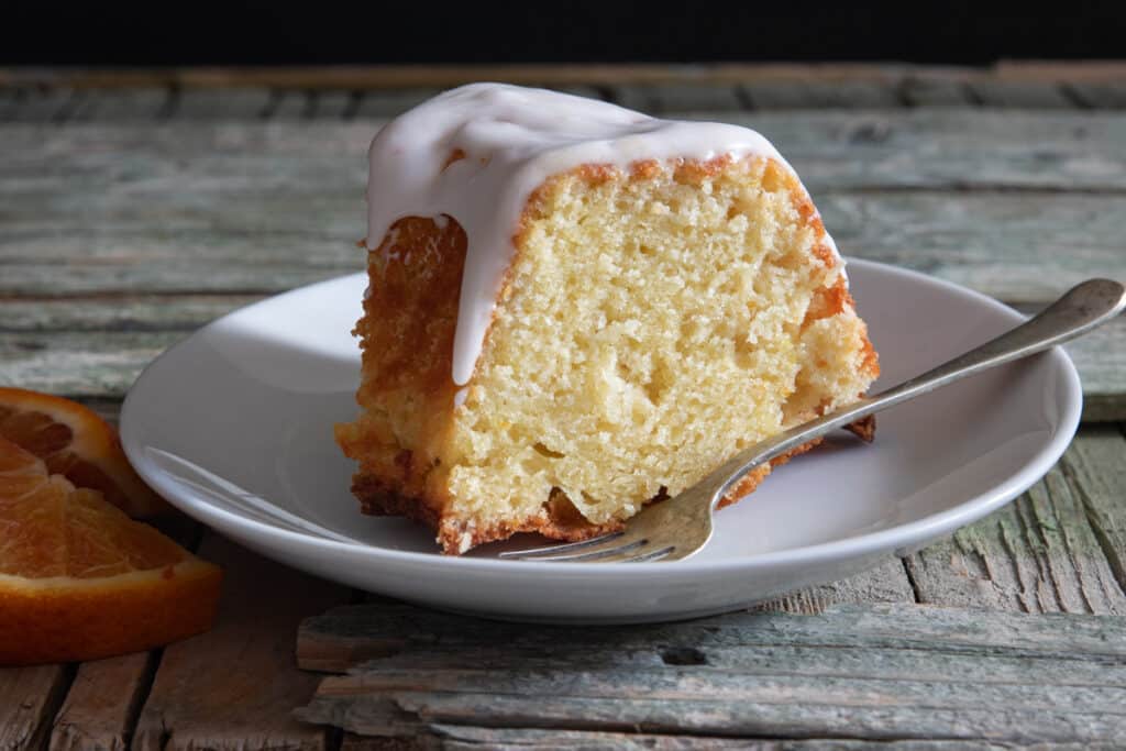 A slice of cake on a white plate.