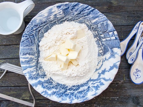 pie dough ingredients flour & butter in a blue bowl