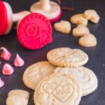 shortbread stamped cookies and cookie stamps on a black board