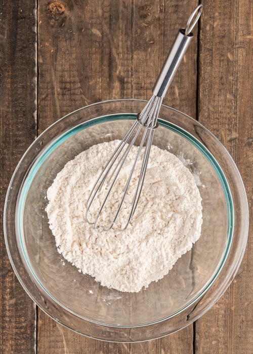 Dry ingredients whisked in a glass bowl.