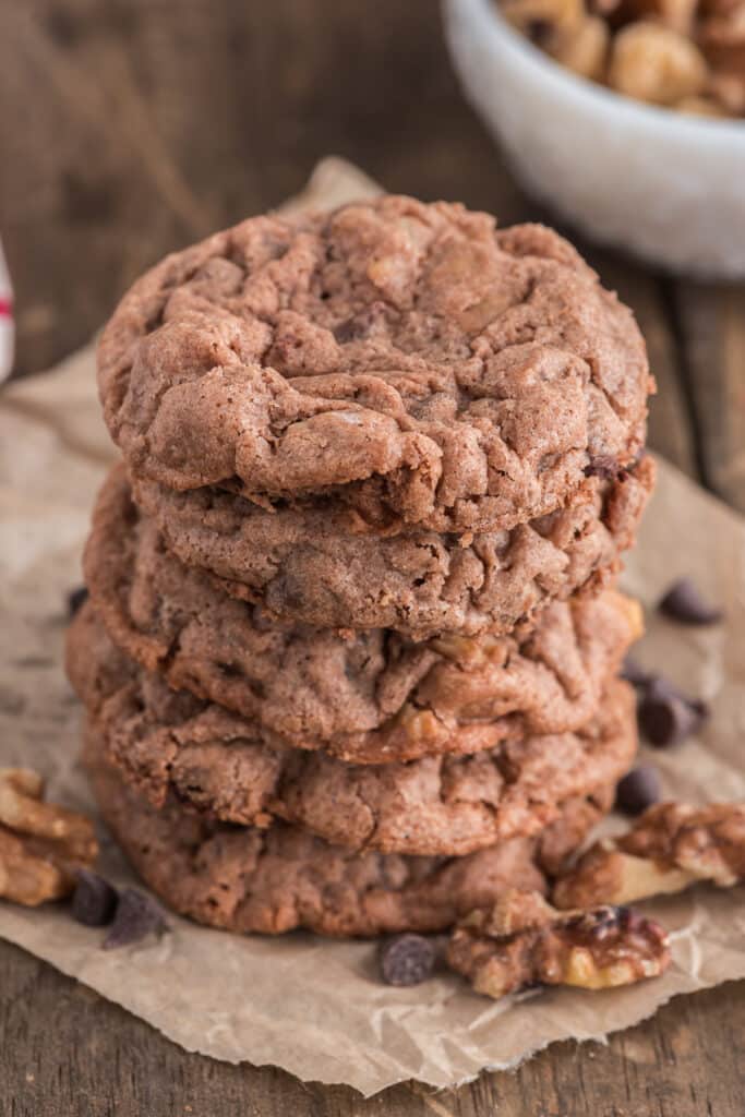 Five cookies stacked on brown paper.