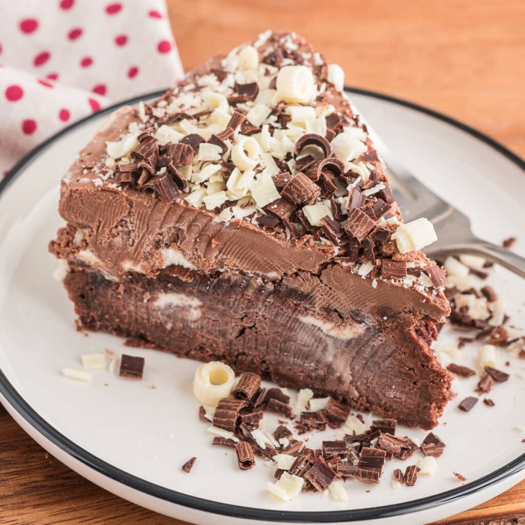 A slice of mousse cake on a white plate.