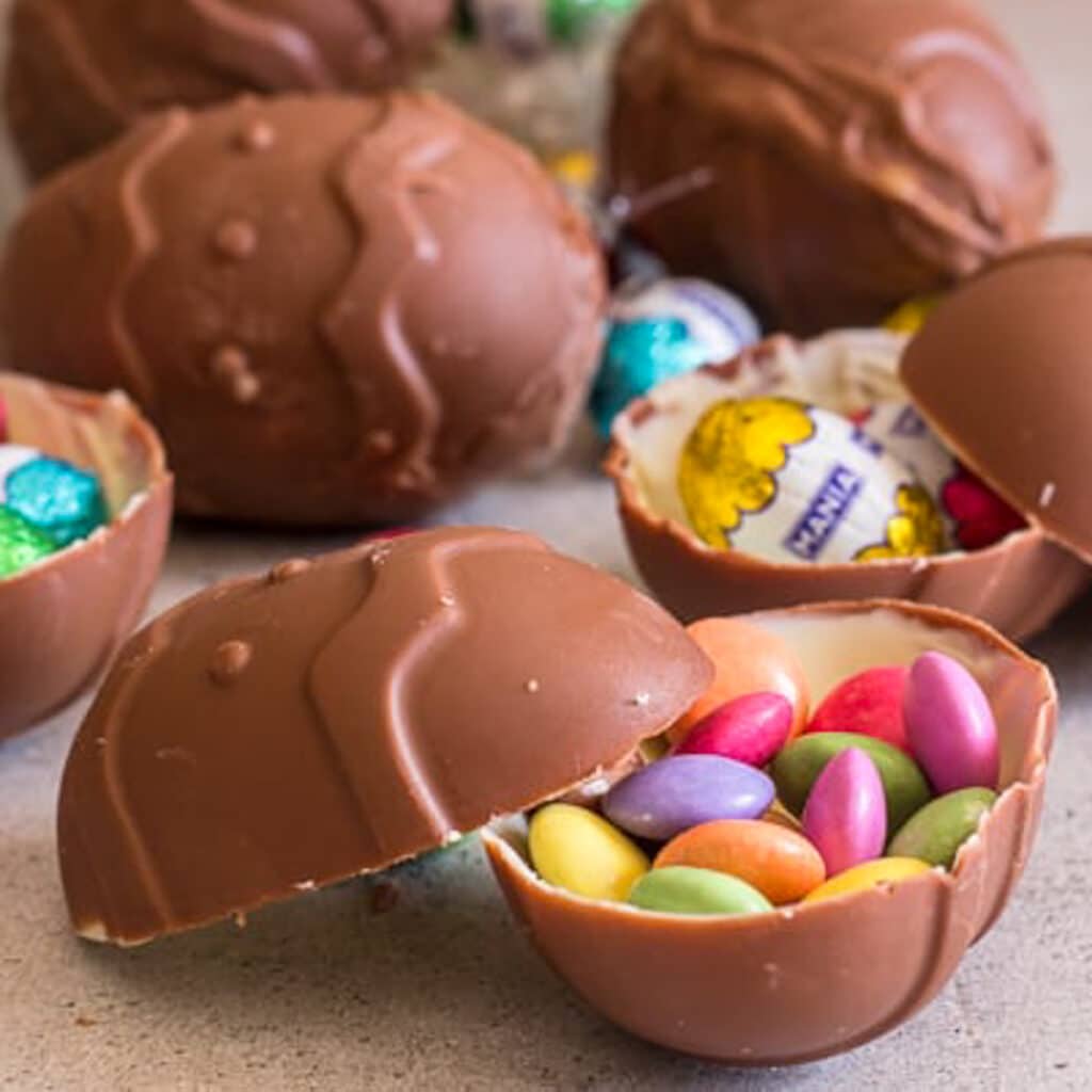 Chocolate easter eggs on a white board with a surprise inside.