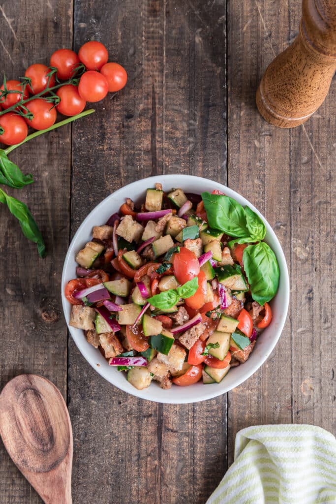 Panzanella salad in a white bowl.