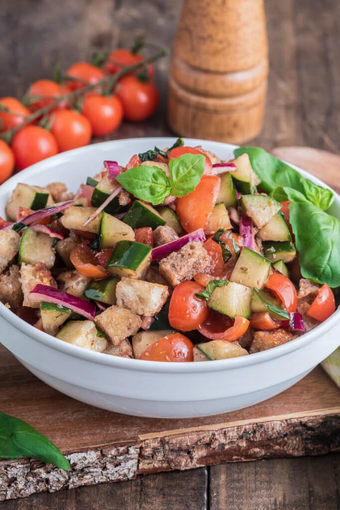 Panzanella salad in a white bowl.