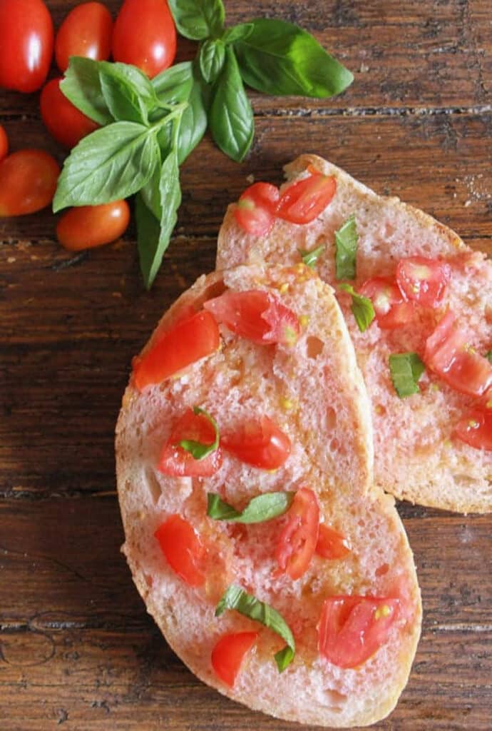 Two slices of bread with sliced tomatoes, oil and salt.