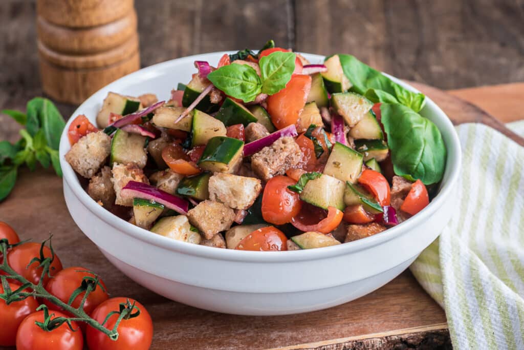 Panzanella salad in a white bowl.