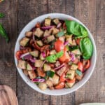 Panzanella salad in a white bowl.