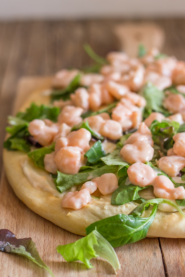 shrimp pizza on a cutting board