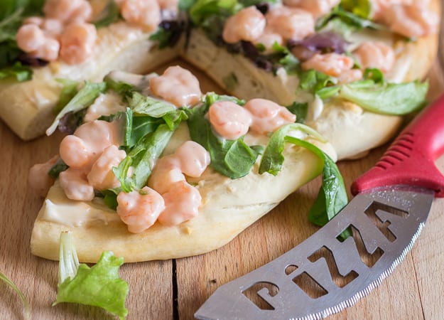 shrimp pizza with a slice cut