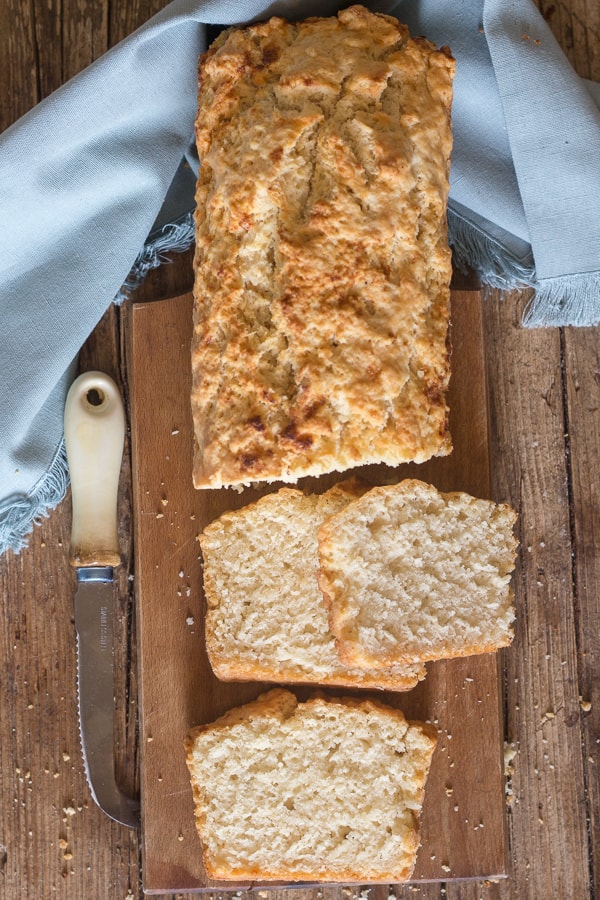 beer bread with three slices on a board