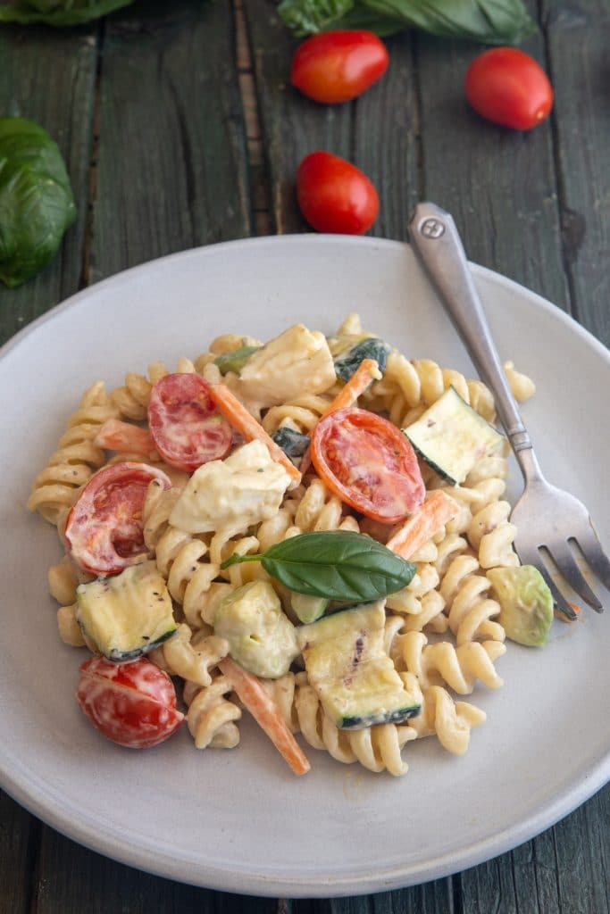 Creamy pasta salad on a white plate.