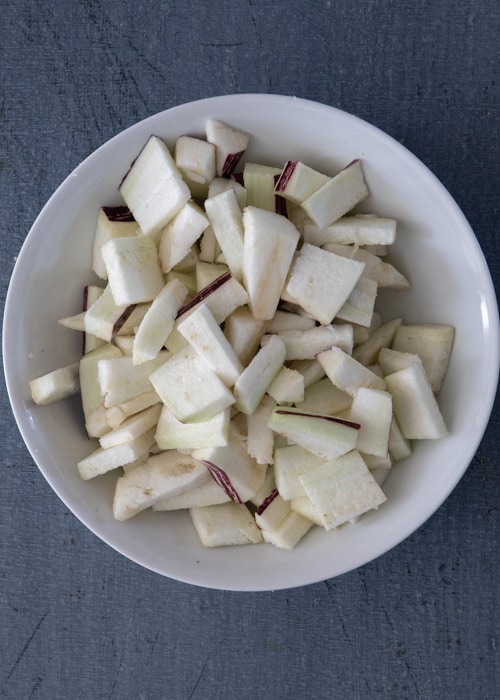 The eggplant and salt in a white bowl.