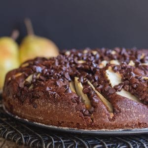 chocolate pear cake on a black wire rack