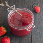 jam in a jar with some on a spoon