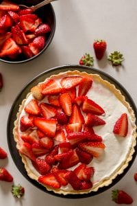 strawberry pie with strawberries in a black bowl
