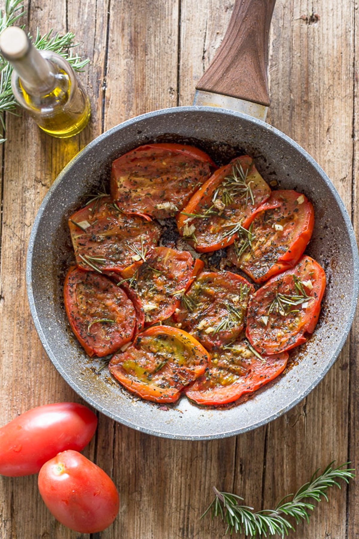 Fried tomatoes in a frying pan.