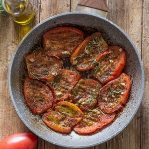 pan fried tomatoes in a frying pan.