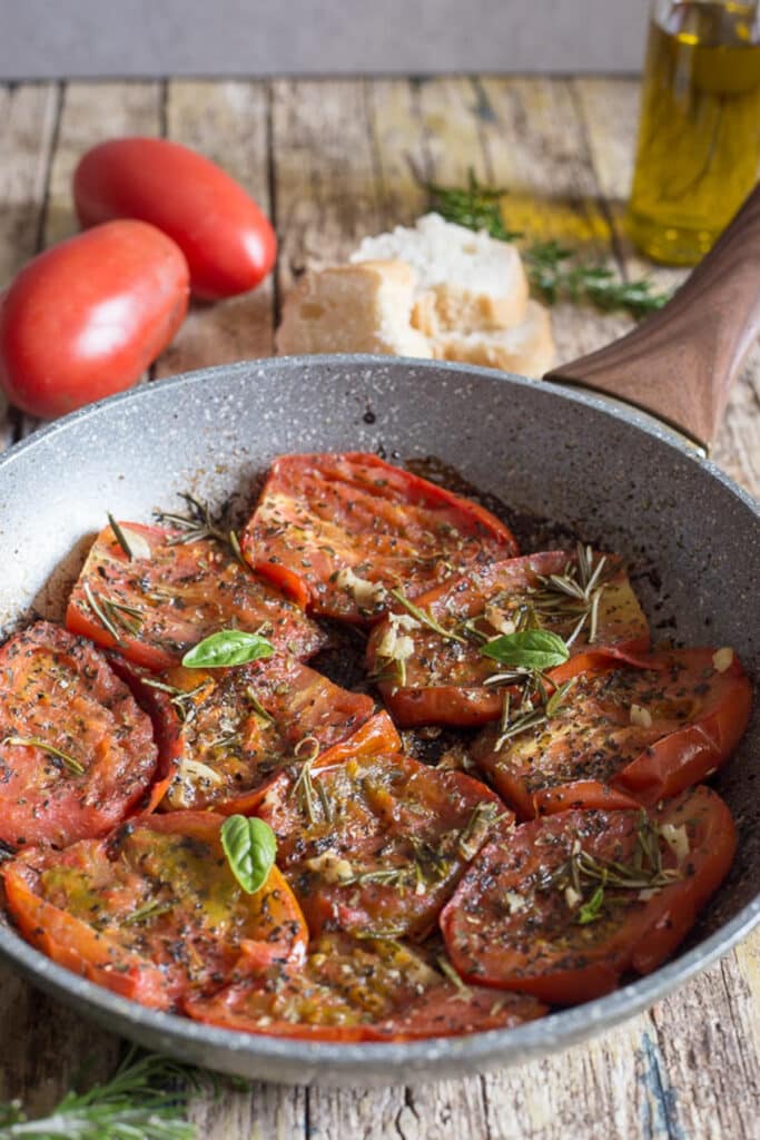 Italian fried tomatoes in a pan.