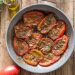 Fried tomatoes in a frying pan.