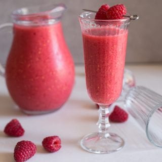 raspberry slush in a glass and jug