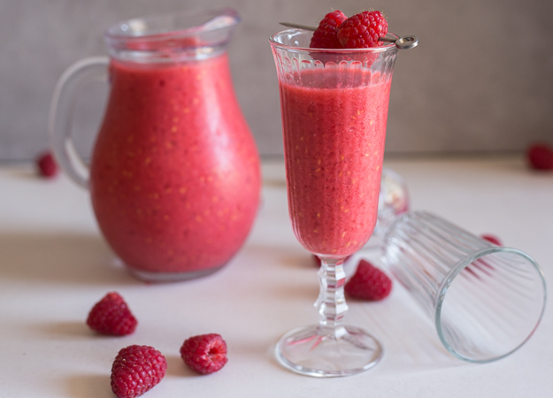 raspberry slush in a glass and jug