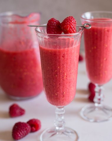 raspberry slushie in 2 glasses and a jug