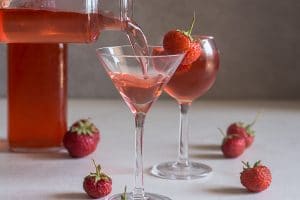 strawberry liqueur pouring into a glass