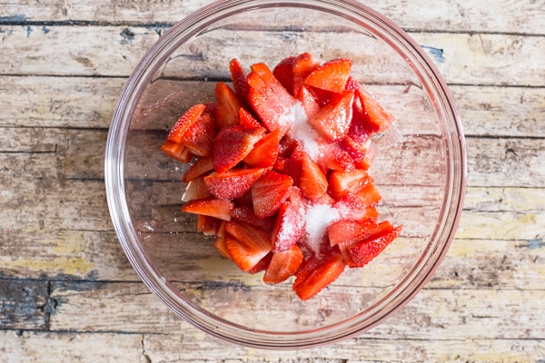 freezing strawberries, sliced in a bowl with sugar
