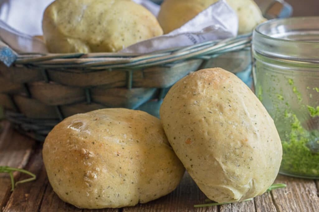 Two rolls on a board and some in a basket.