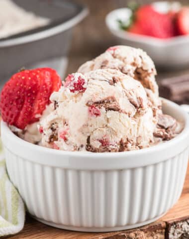 Strawberry ripple ice cream in a white bowl.