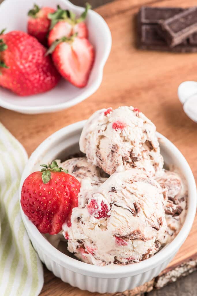 Strawberry ripple ice cream in a white bowl.