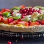fruit pizza recipe up close on a black wire rack