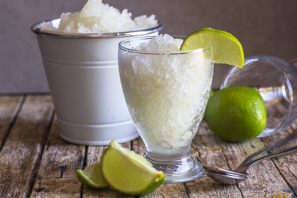 lime granita in a white bucket and some in a glass
