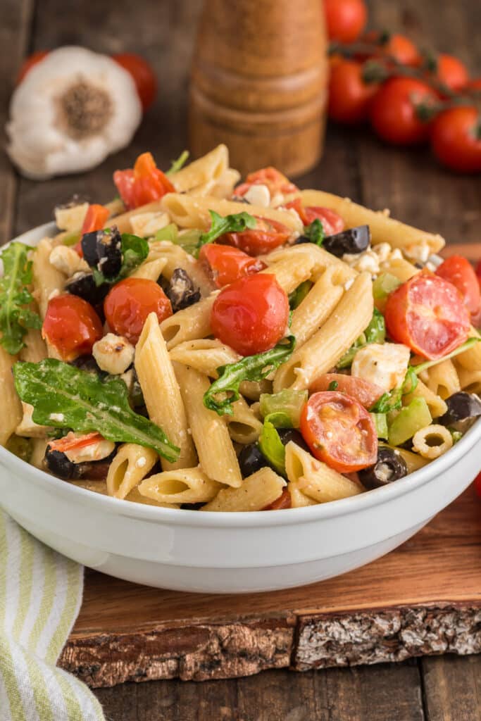 Mediterranean pasta salad in a white bowl.