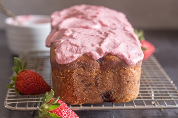 strawberry bread frosted on a wire rack