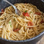 Spaghetti in a black baking dish.