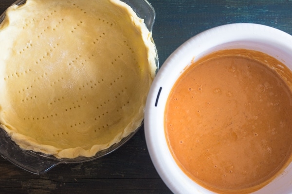 pumpkin pie, crust in dish and filling in bowl