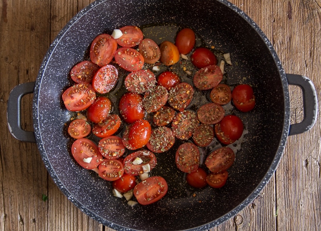 fresh tomatoes in a black pan