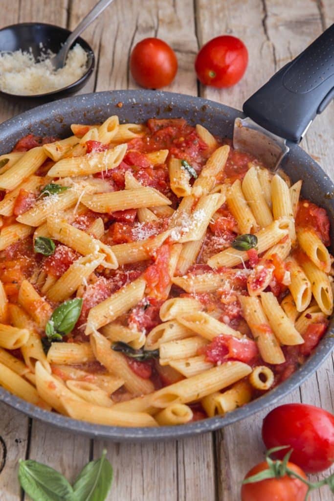 Fresh tomato sauce and pasta in a frying pan.