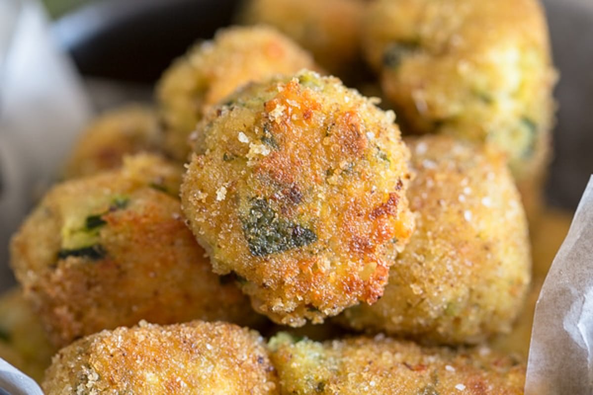 Zucchini bites in a black bowl.