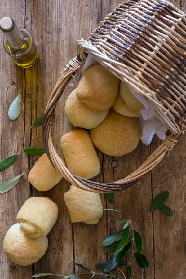 olive oil bread, small rolls falling out of a basket