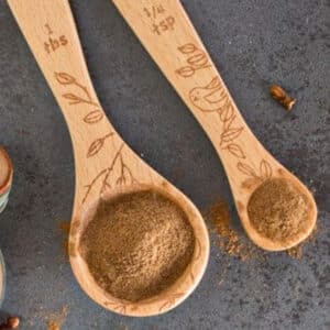 Homemade allspice on two wooden spoons.